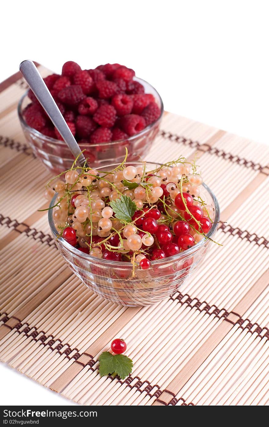 Fresh Raspberry and currant in a crystal bowl isolated