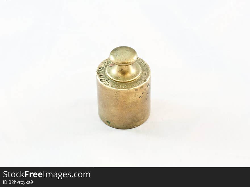 An antique iron weight on white background, useful for conceptual