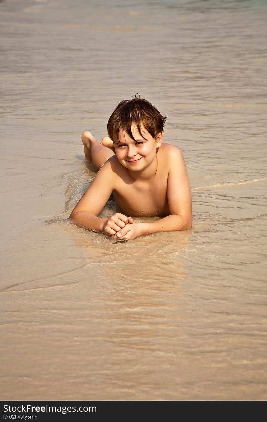 Boy Is Lying At The Beautiful Beach