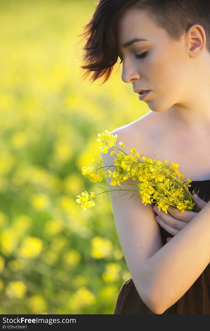 Young girl portrait holding yellow flowers. Young girl portrait holding yellow flowers