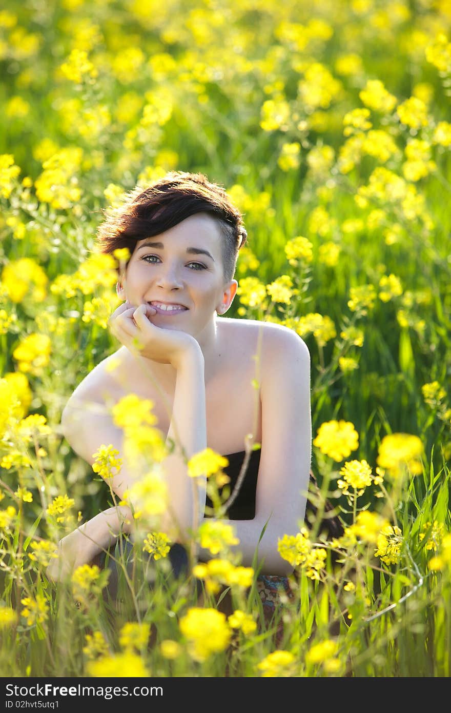 Young modern haired girl smiling on yellow field. Young modern haired girl smiling on yellow field.