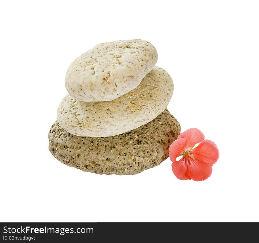 Close up stack of stones and a pink flower