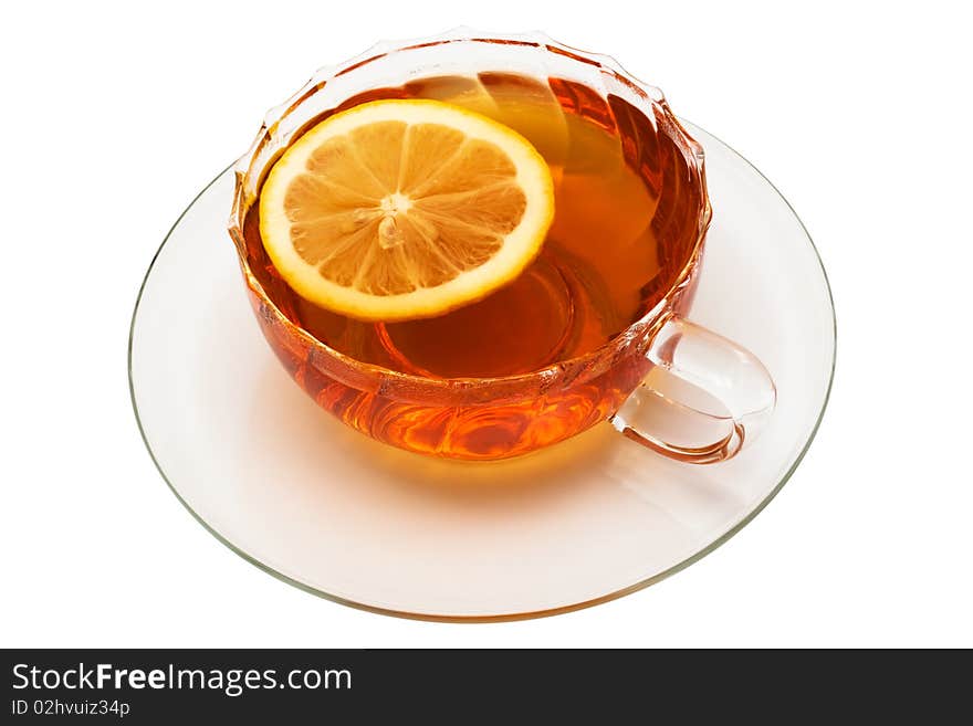 Glass cup with tea and a lemon on a white background