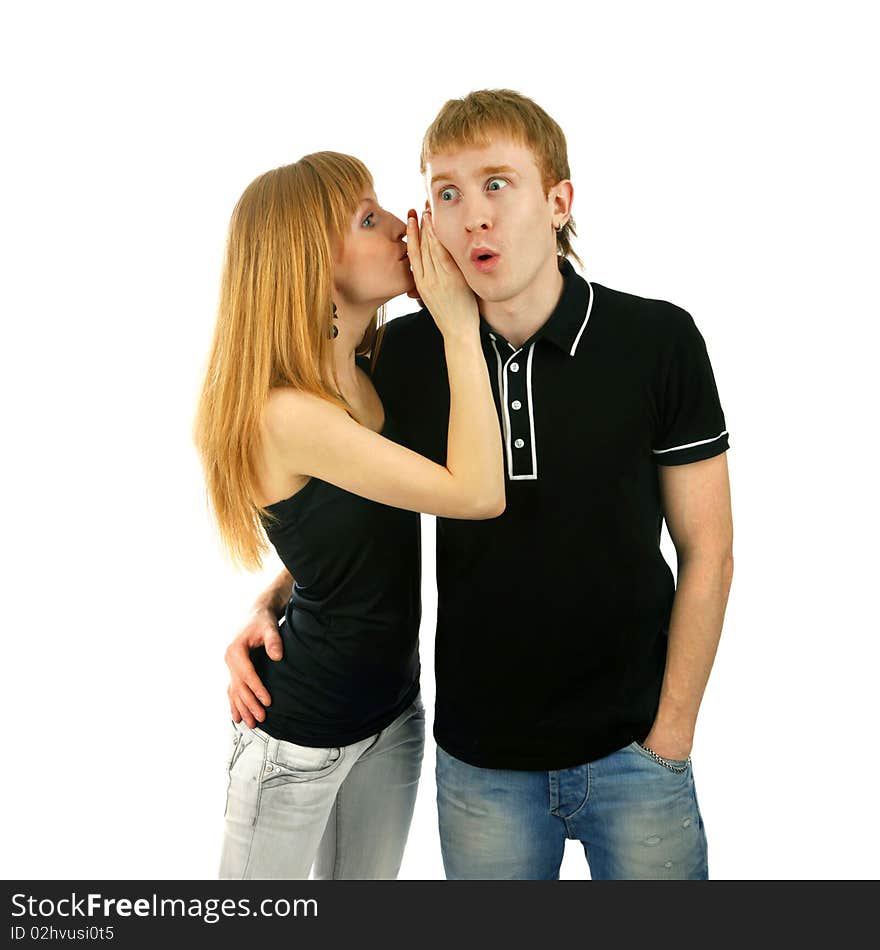 Beautiful woman whispering to a surprised man isolated background. Beautiful woman whispering to a surprised man isolated background