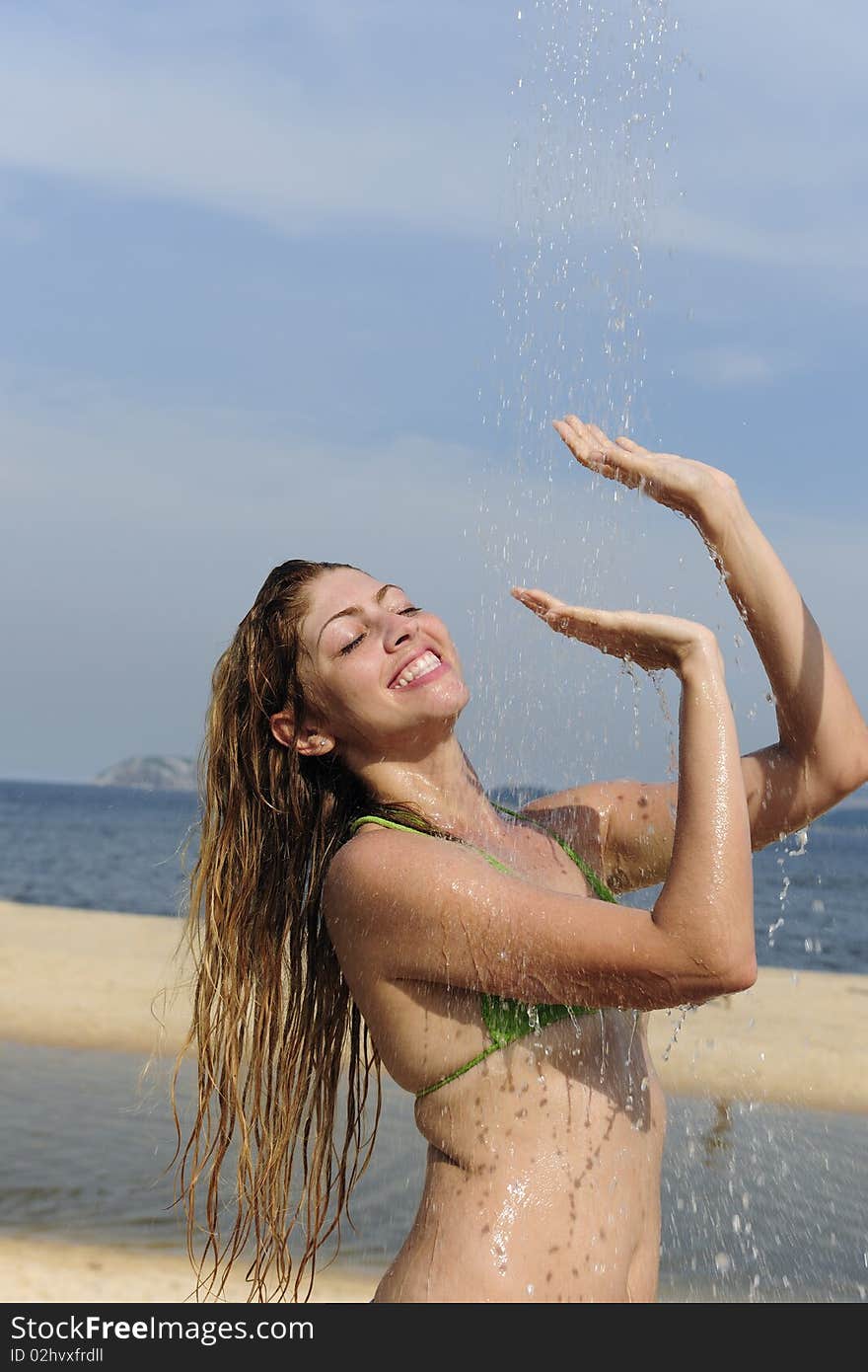 Woman Taking A Shower On The Beach