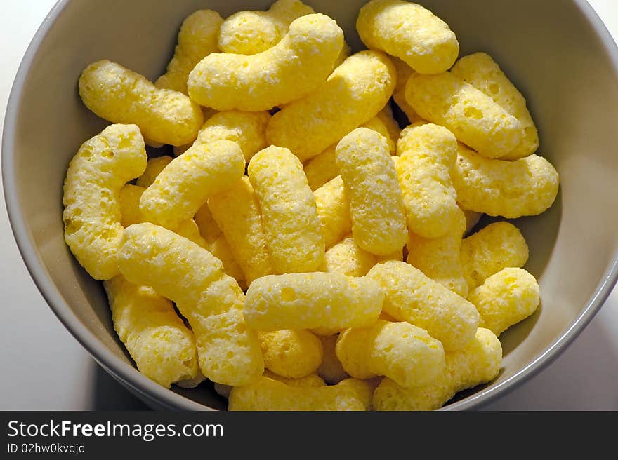 Corn sticks in a bowl close-up on white studio shot