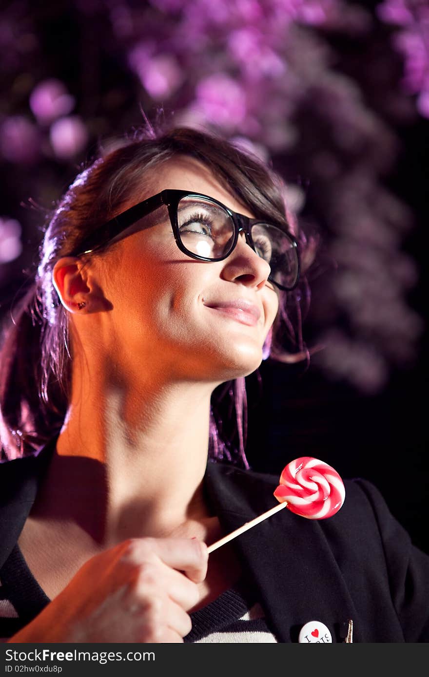 Lovely girl wearing glasses and holding a lollipop. Lovely girl wearing glasses and holding a lollipop