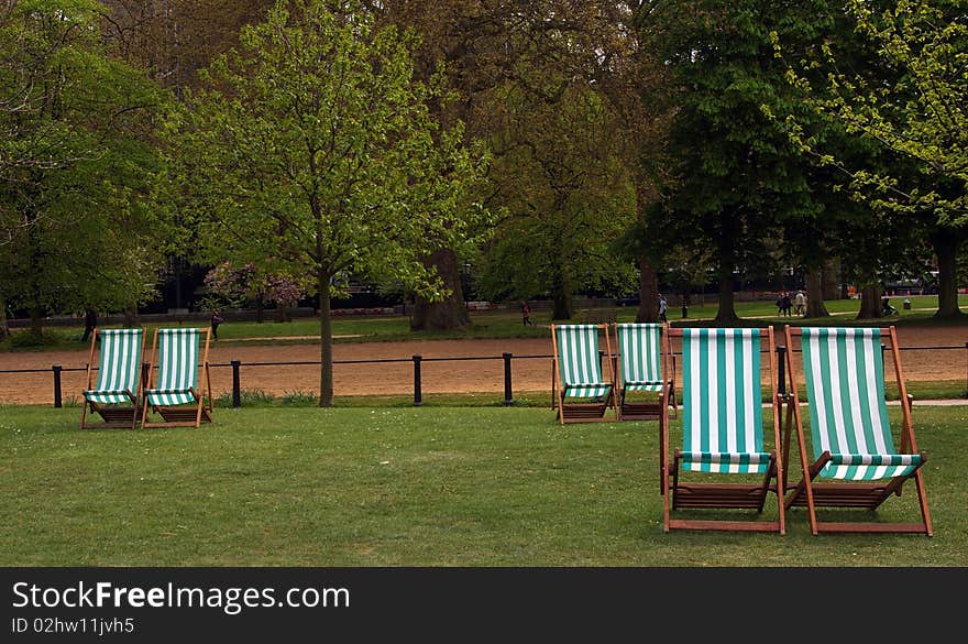 Six deckchairs in Hyde Park, London, England. Six deckchairs in Hyde Park, London, England.