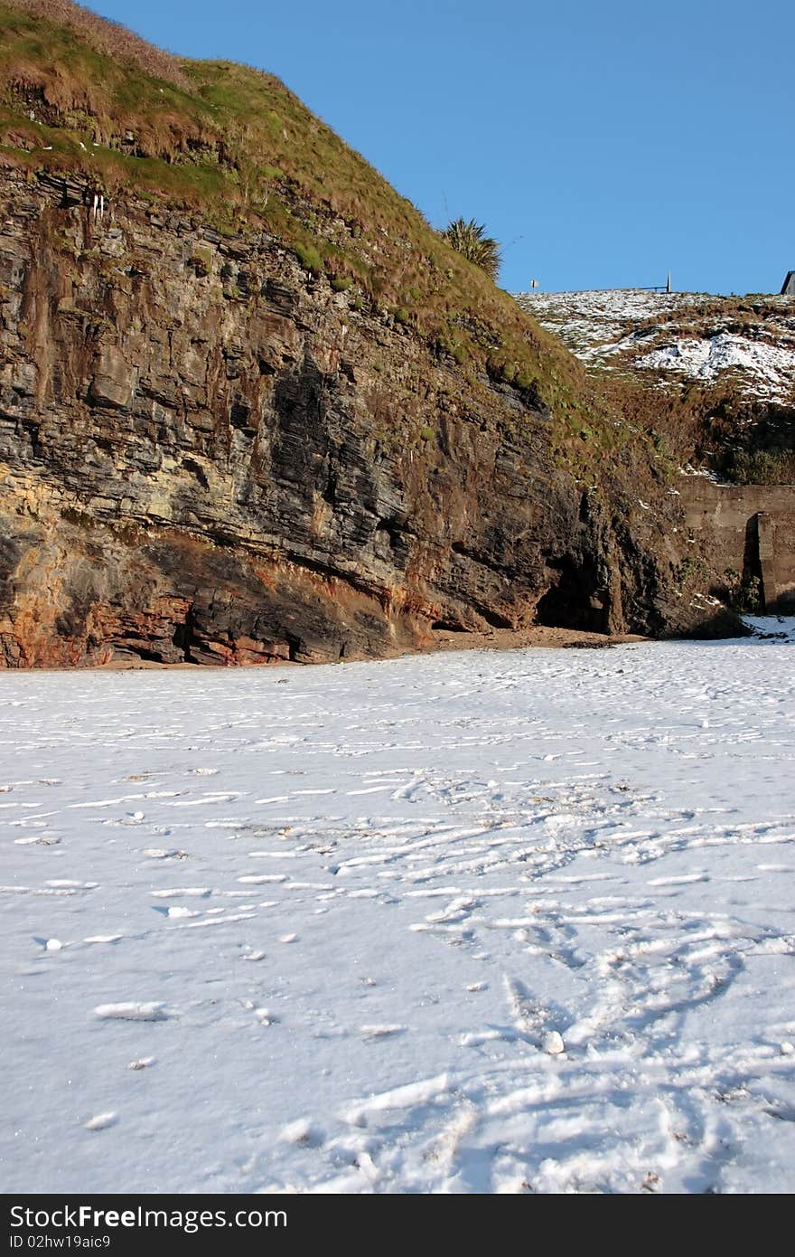 An empty rocky beach and cliffs on a cold winters day. An empty rocky beach and cliffs on a cold winters day