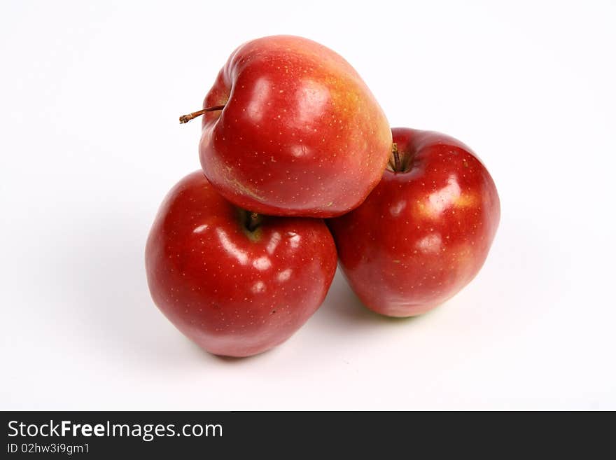 Three red apples on white background