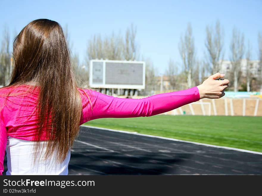 Young woman at the sport competition with stopwatch