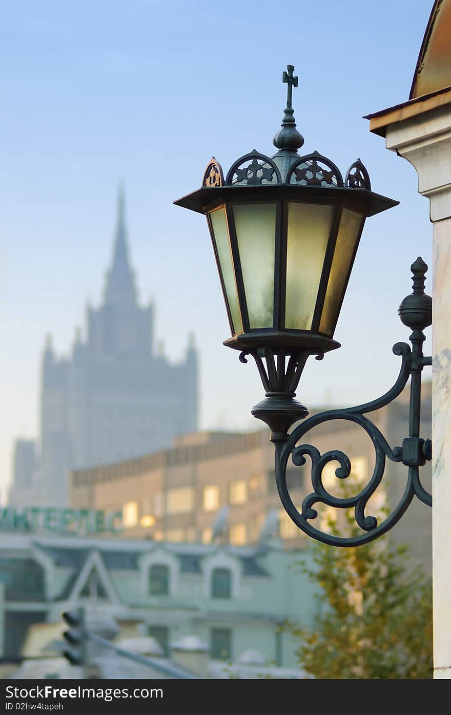 Wall mount street lamp against urban background