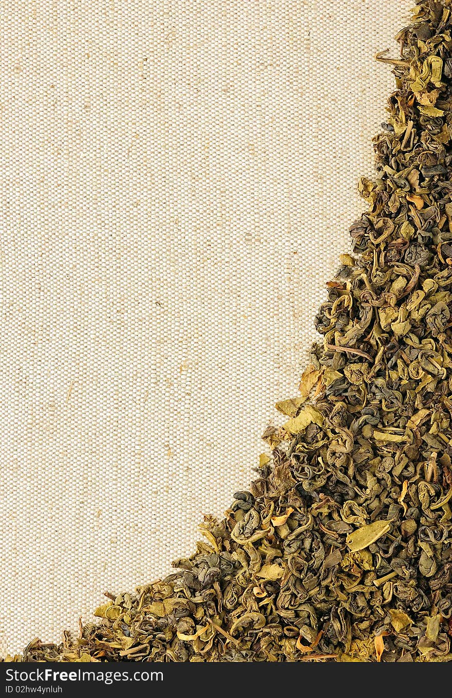 Dry green tea leaves on a sackcloth