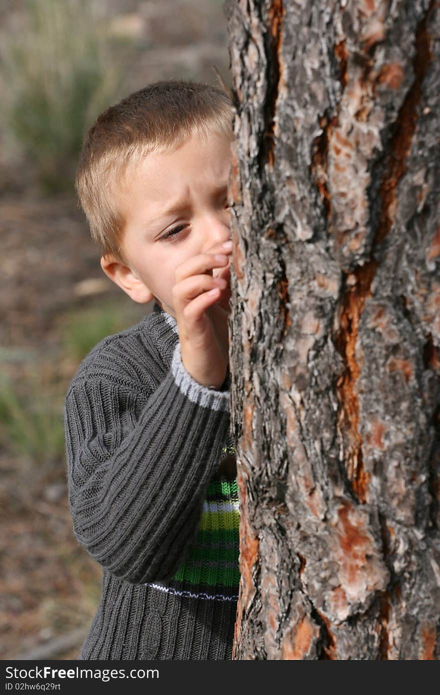 Beautiful blond boy playing outdoors on a spring day