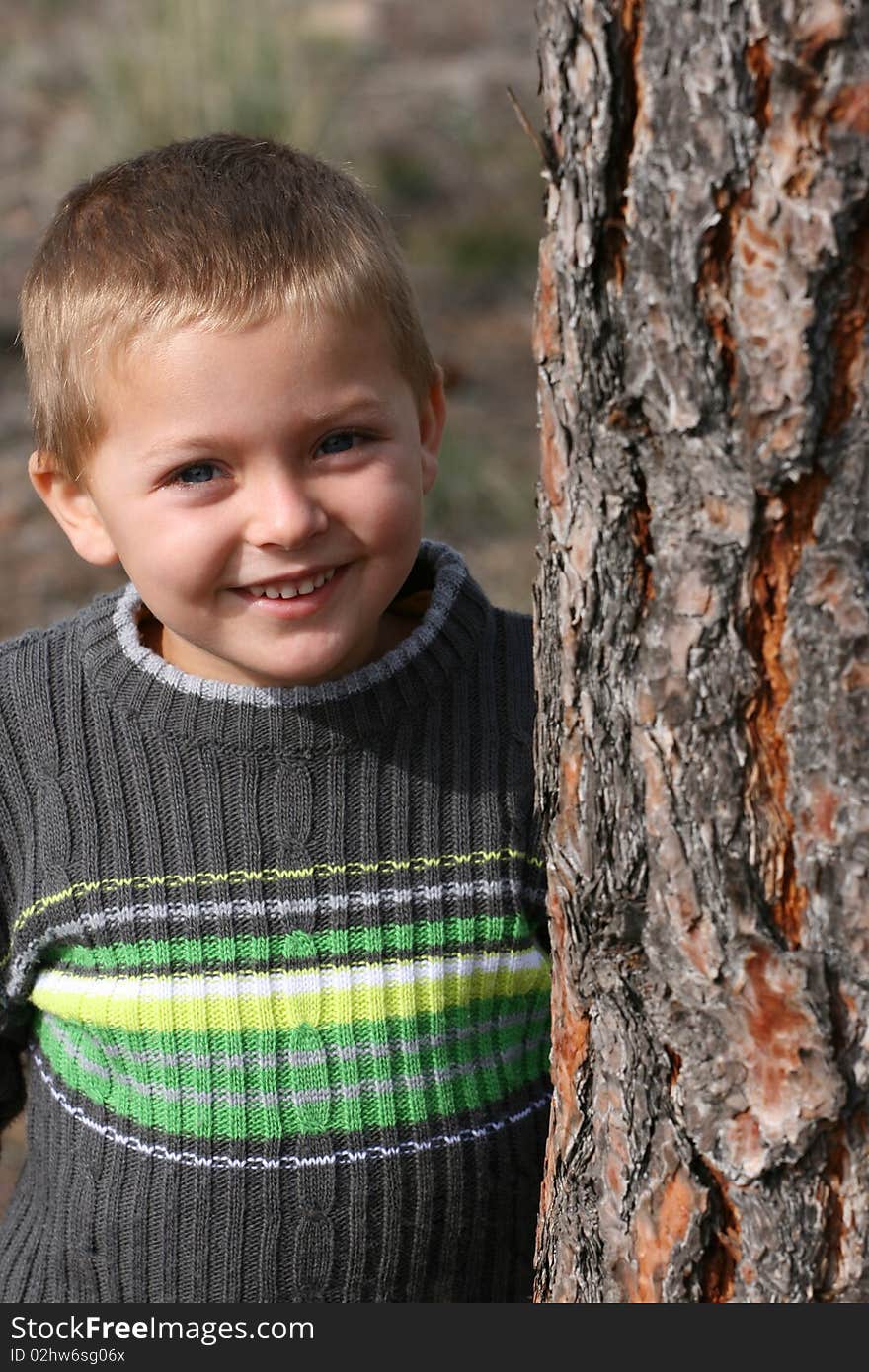 Beautiful blond boy playing outdoors on a spring day