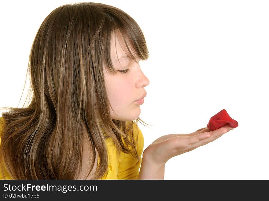 Girl blows on flower petal isolated in white