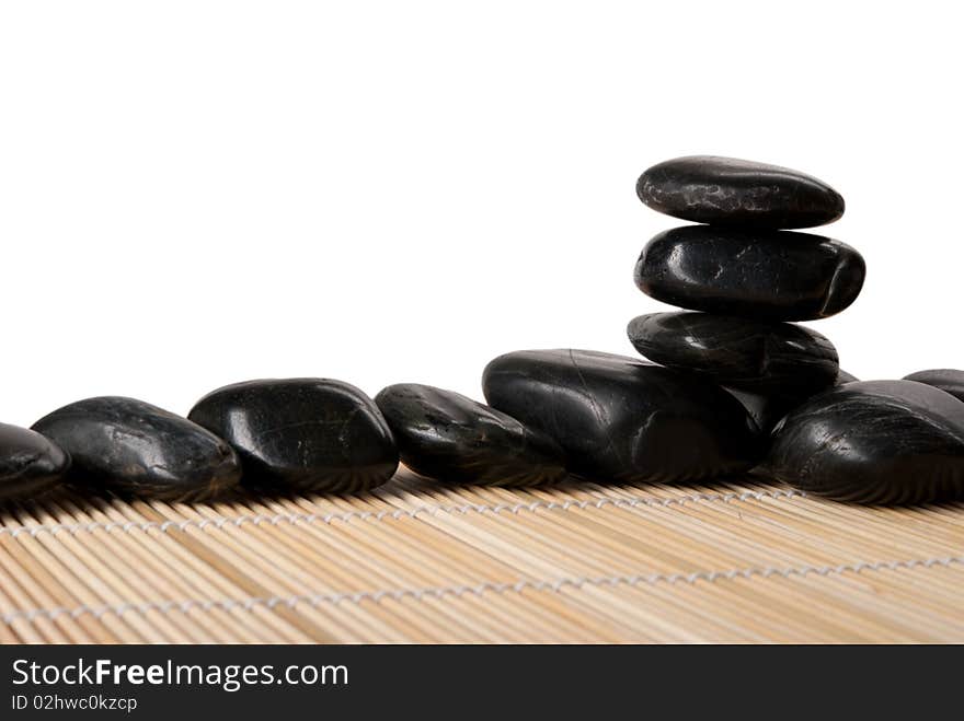 Some stones lie on mat isolated in white