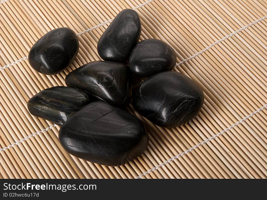 Dark brilliant stones lie on mat