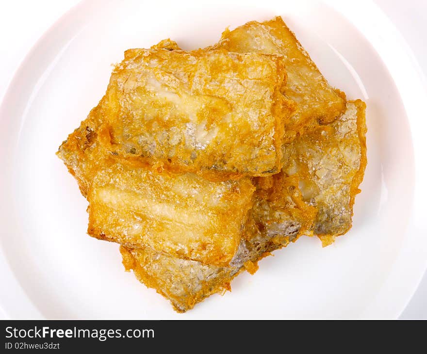 Fresh fried Conger fish. On a plate. Close up on white background