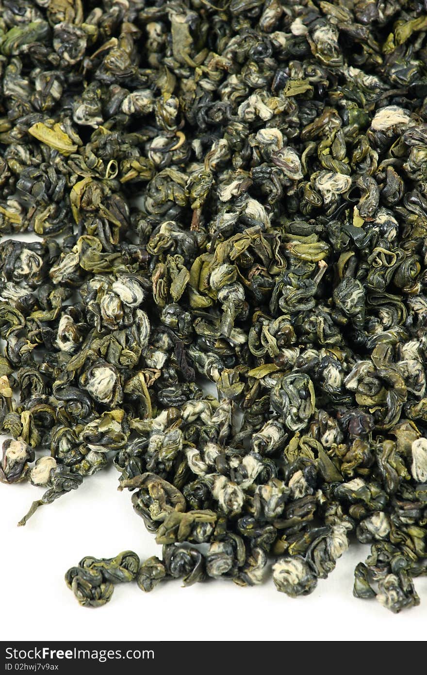 Green tea leaves on a white background