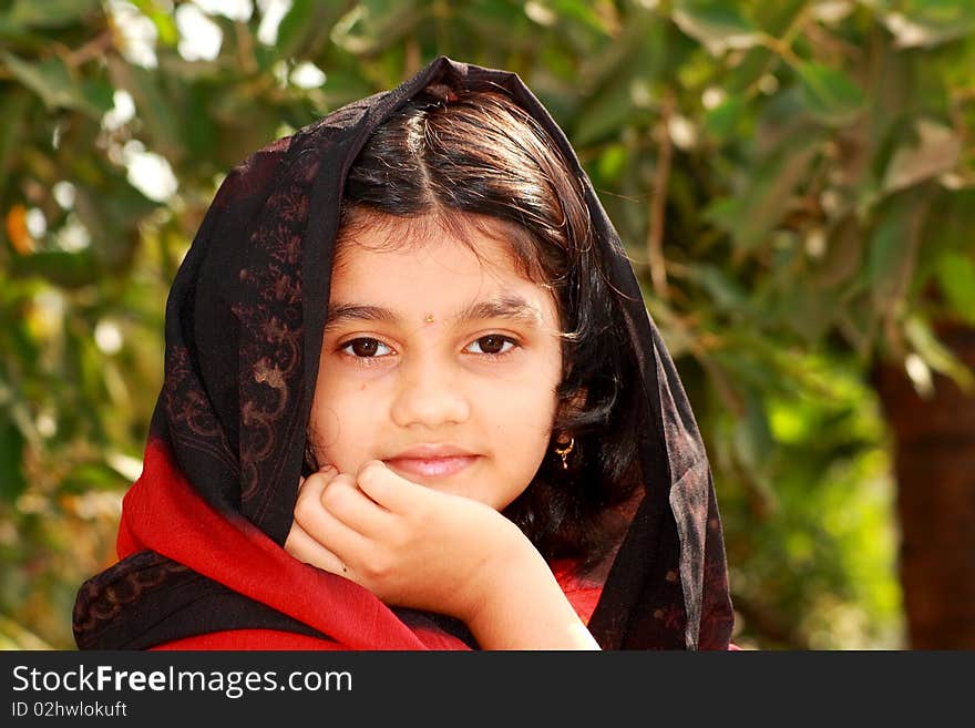 A small Indian girl with her nice and beautiful face and warm thoughts. A small Indian girl with her nice and beautiful face and warm thoughts.