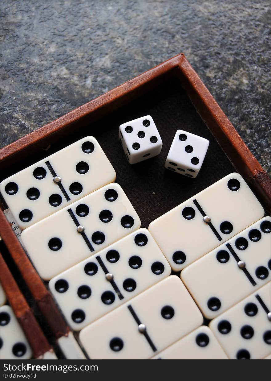 Closeup of a dominoes laying on a flat surface.