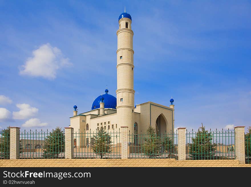 Kazakh muslim orthodox Islamic mosque. A moon on a dome on a blue sky.