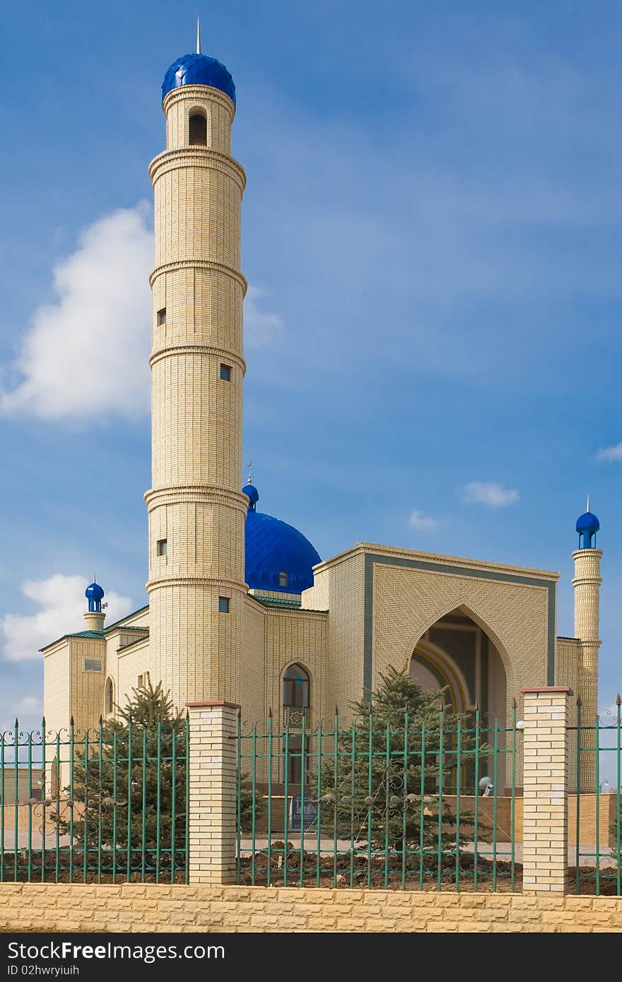 Kazakh muslim orthodox Islamic mosque. A moon on a dome on a blue sky.