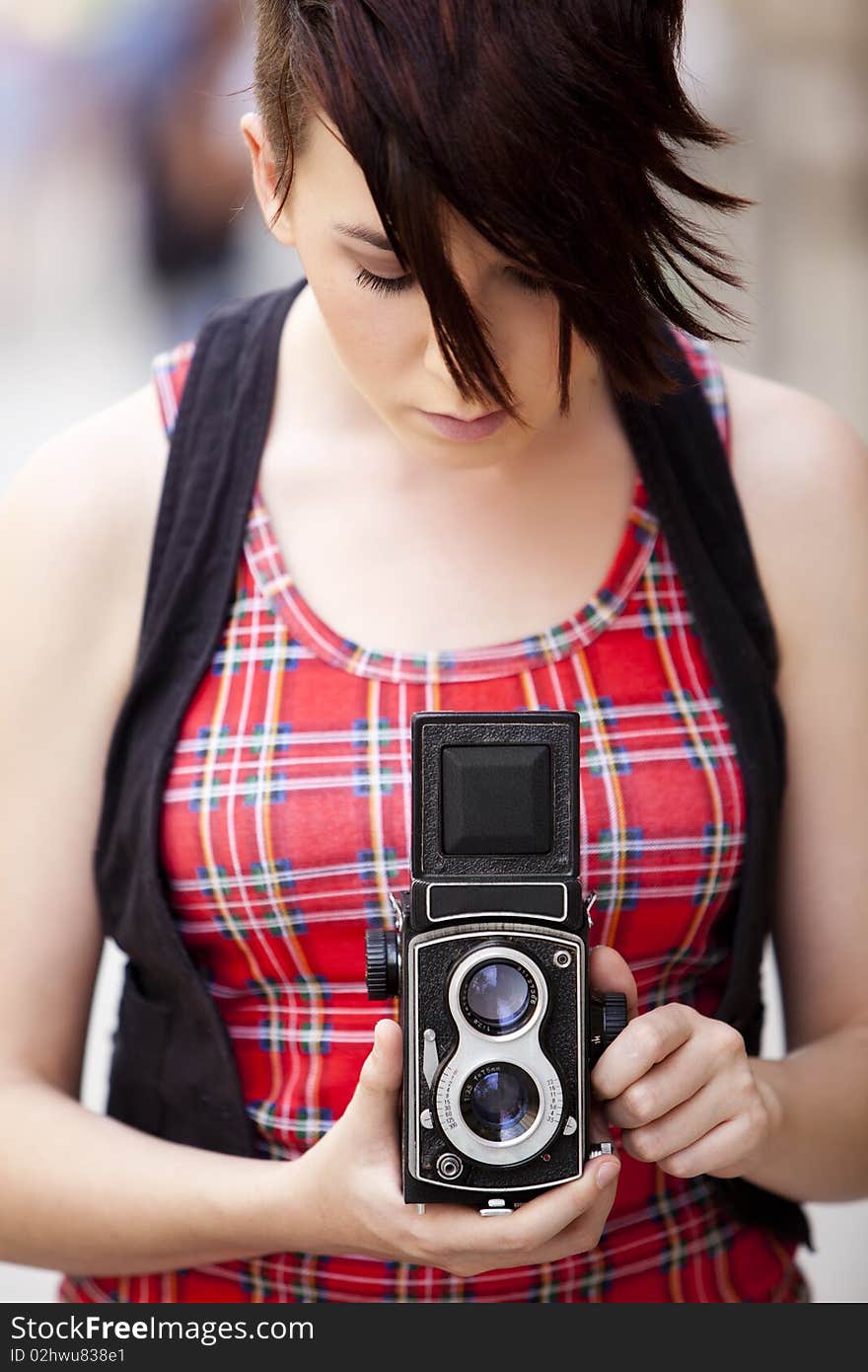 Young female photographer using old 6x6 medium format camera.