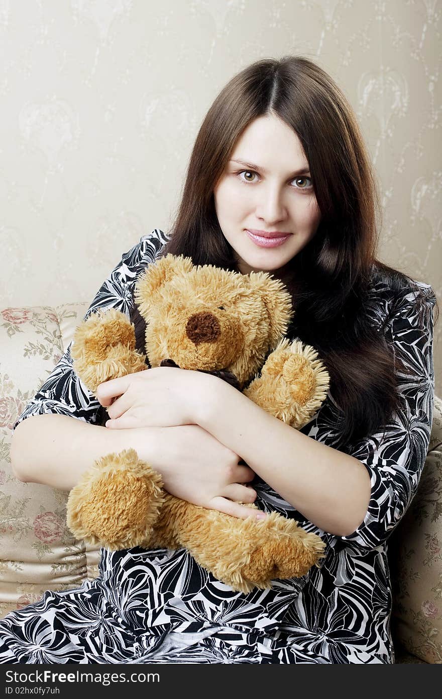 Pregnant Woman Sitting On A Vintage Couch