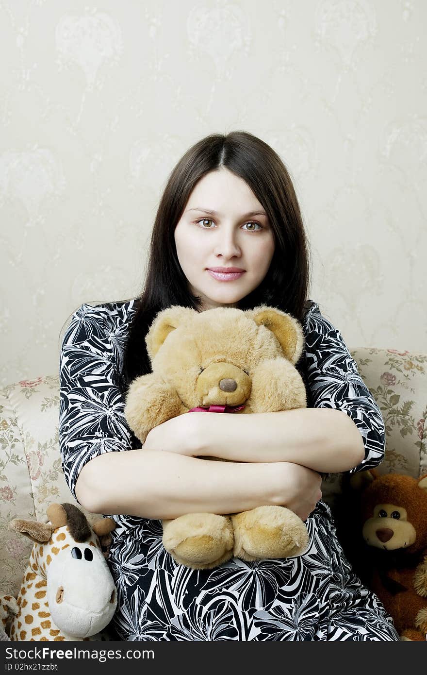 Pregnant woman sitting on a vintage couch