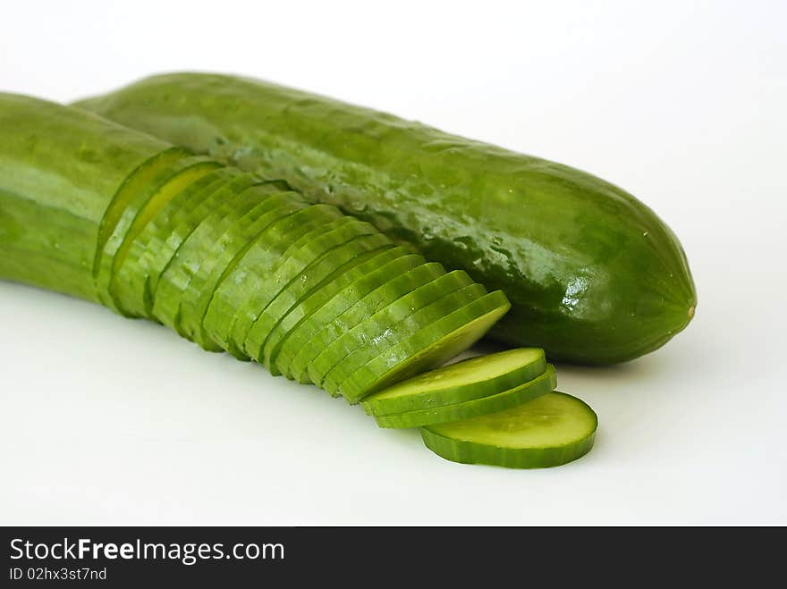 Two green cucumbers on the white background