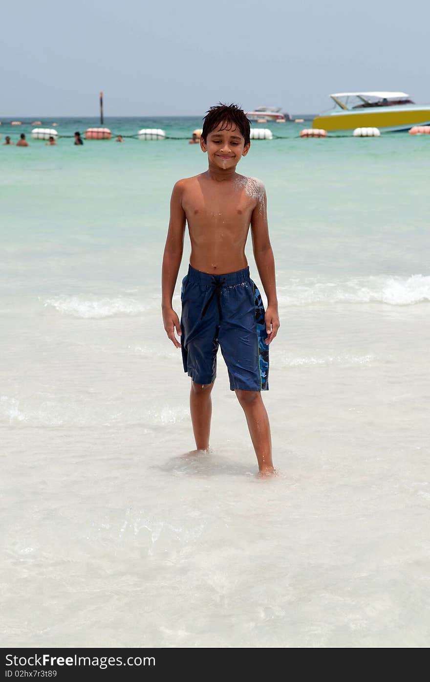 An handsome Indian kid playing in the water