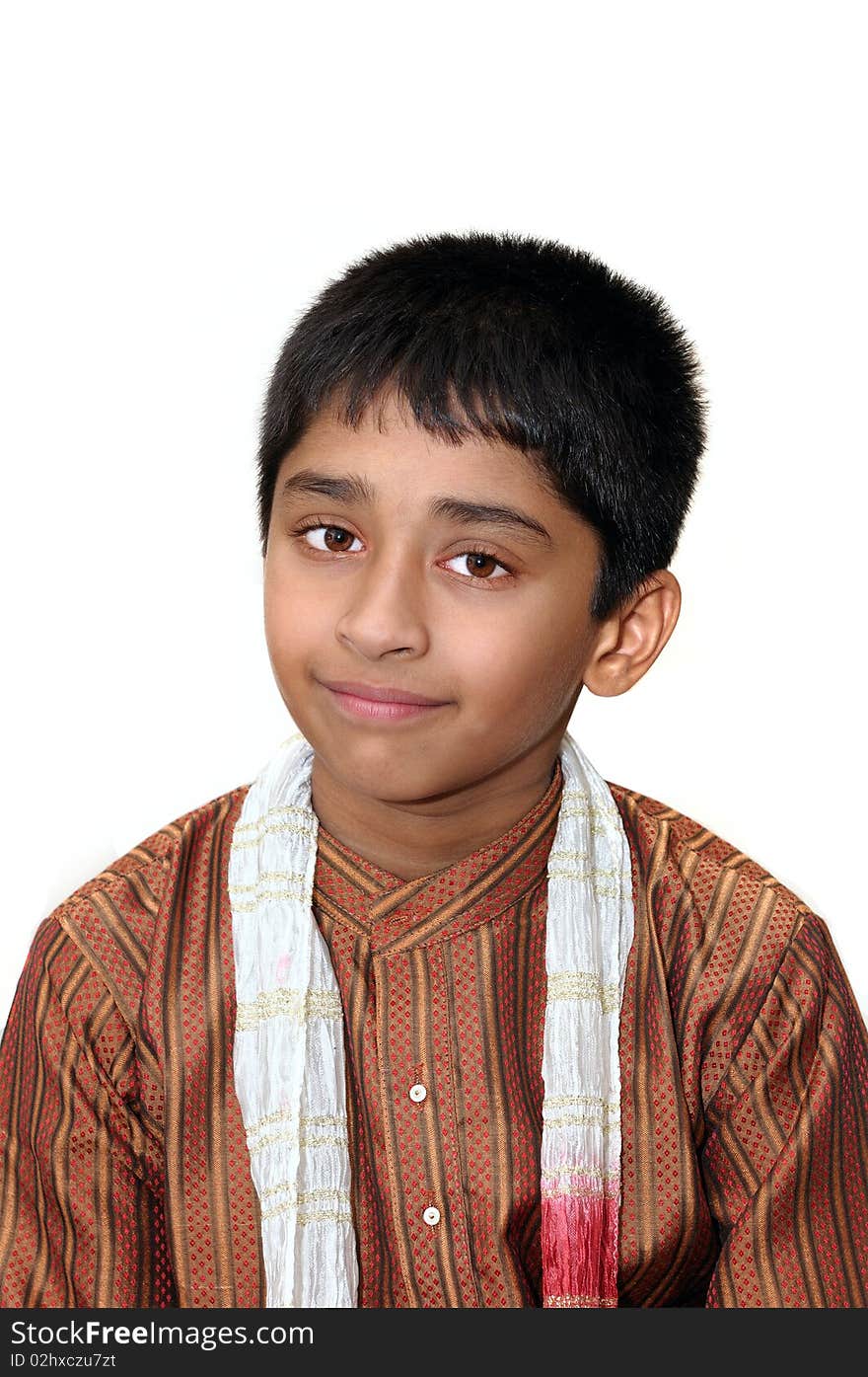 An handsome Indian kid dressed very traditionally