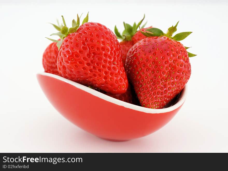 A saucer with strawberries isolated on white background. A saucer with strawberries isolated on white background