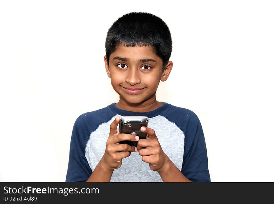 An handsome Indian kid playing games with teh cell phone