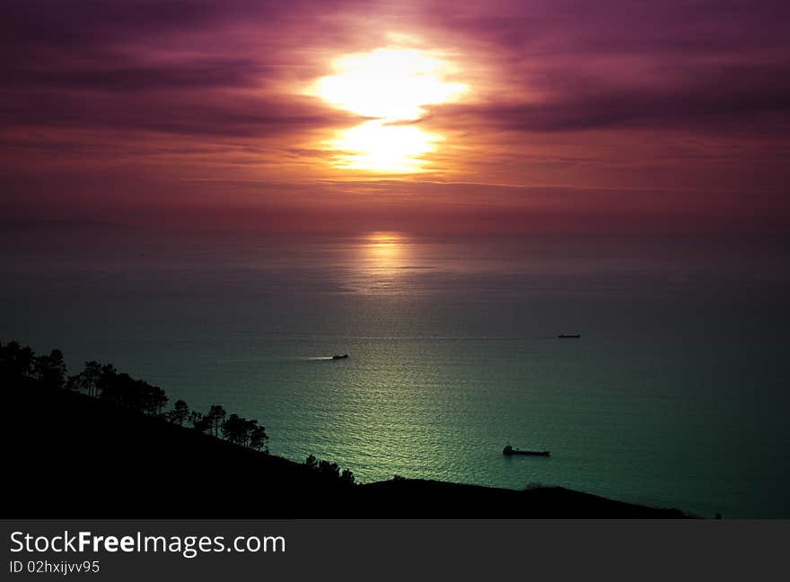 Boats fishing under a beautiful sunset in the sea. Boats fishing under a beautiful sunset in the sea.