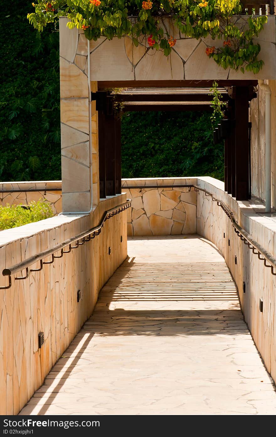 A Portrait of Garden Downhill Walkway with Hanging Plants and Flowers