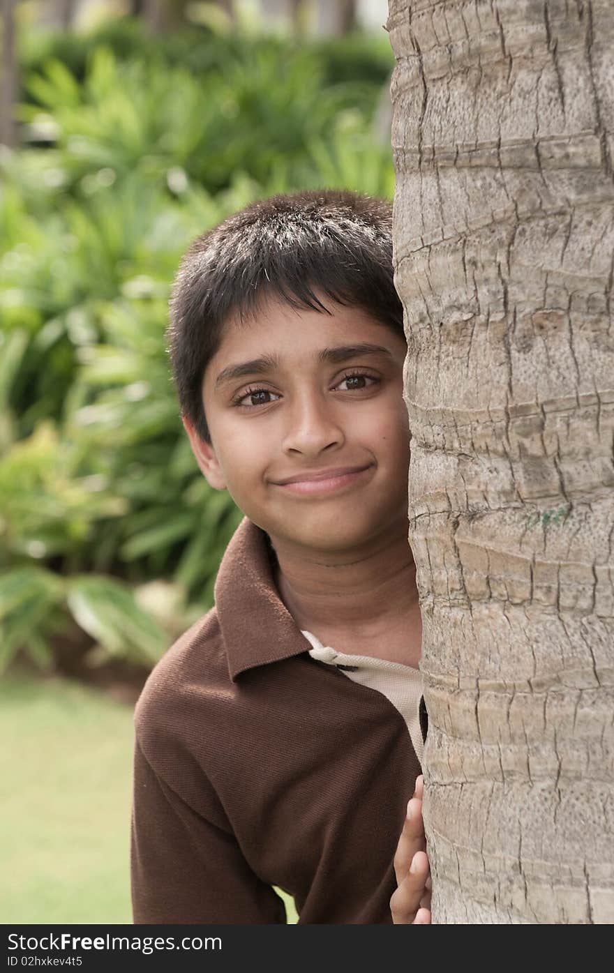 An handsome Indian kid peeping thru the trunk