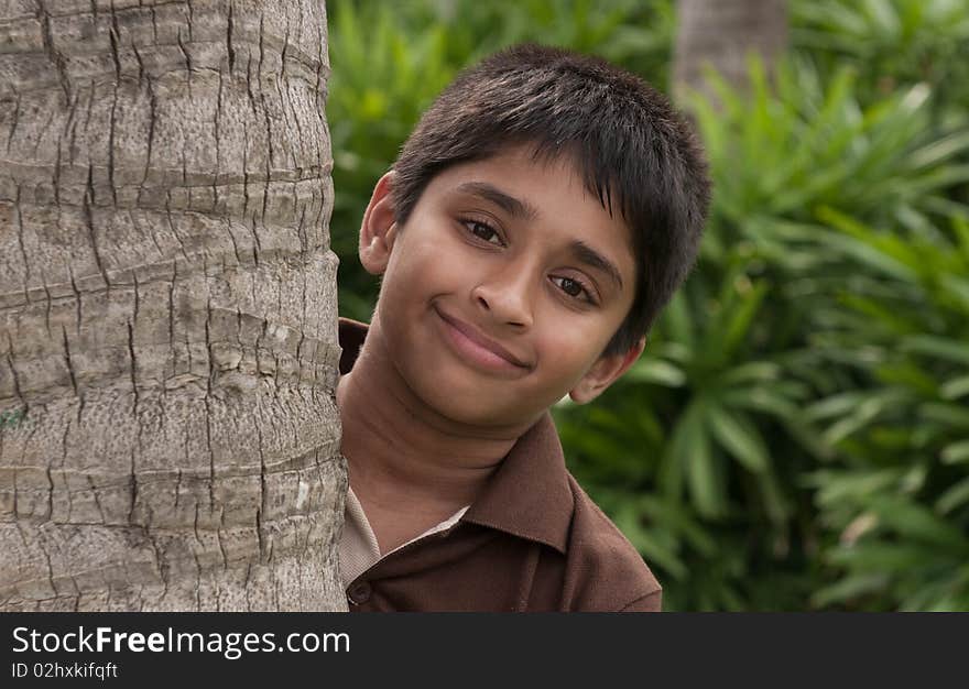 An handsome Indian kid peeping thru the trunk