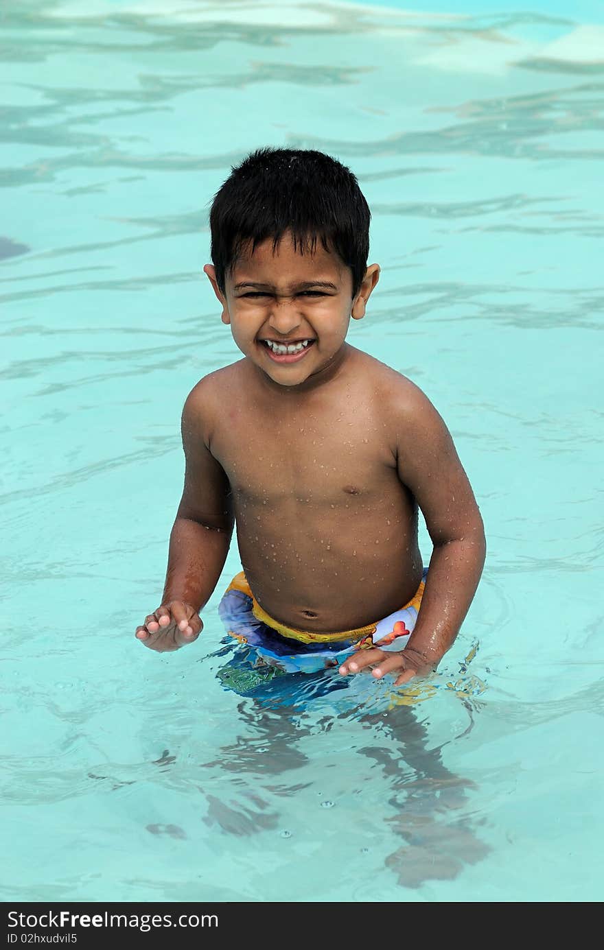 An handsome Indian kid ready to swim by the pool. An handsome Indian kid ready to swim by the pool