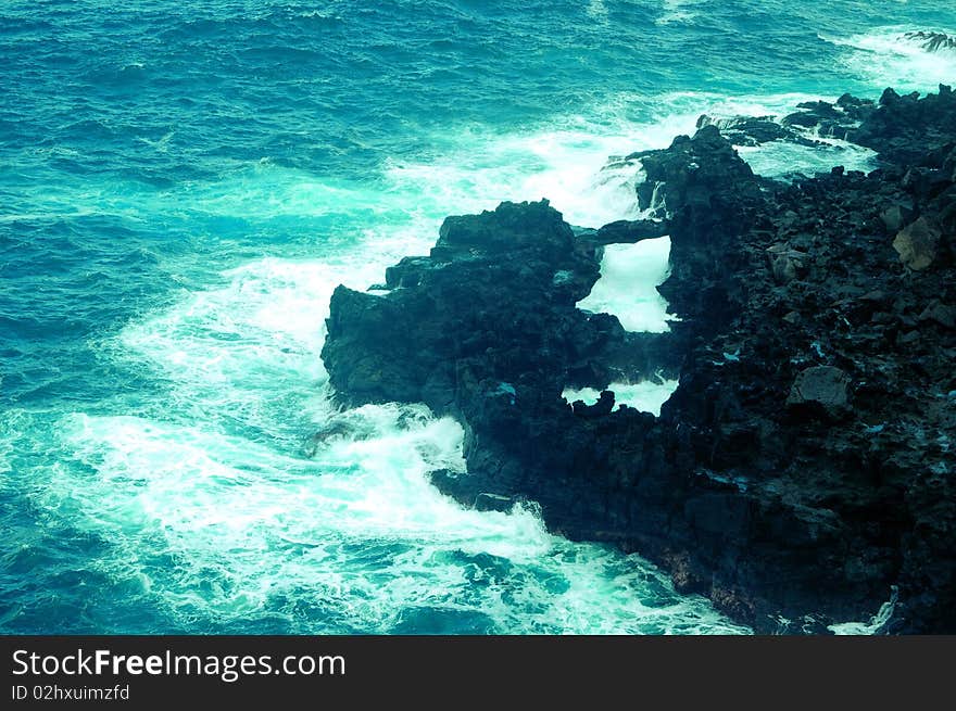 Fiery waves hitting the dark rock on the pacific coast. Fiery waves hitting the dark rock on the pacific coast