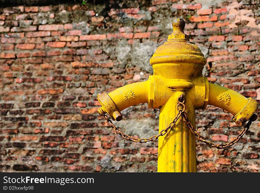 The fire tube in front of the old brick wall