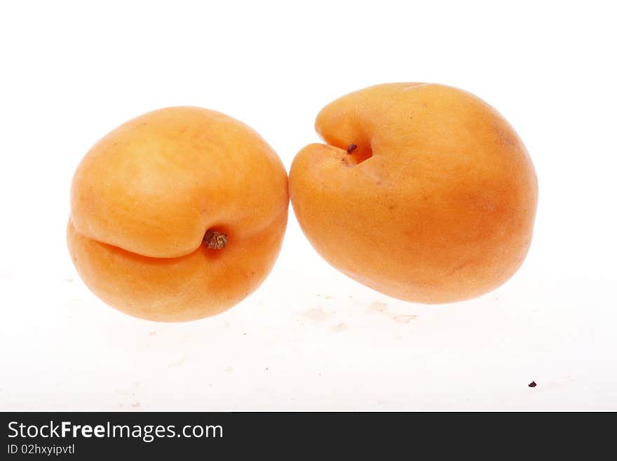 Two fresh apricots isolated on white background