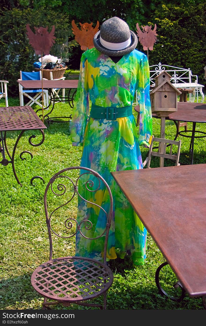 Colorful vintage female dress, exhibited in the garden