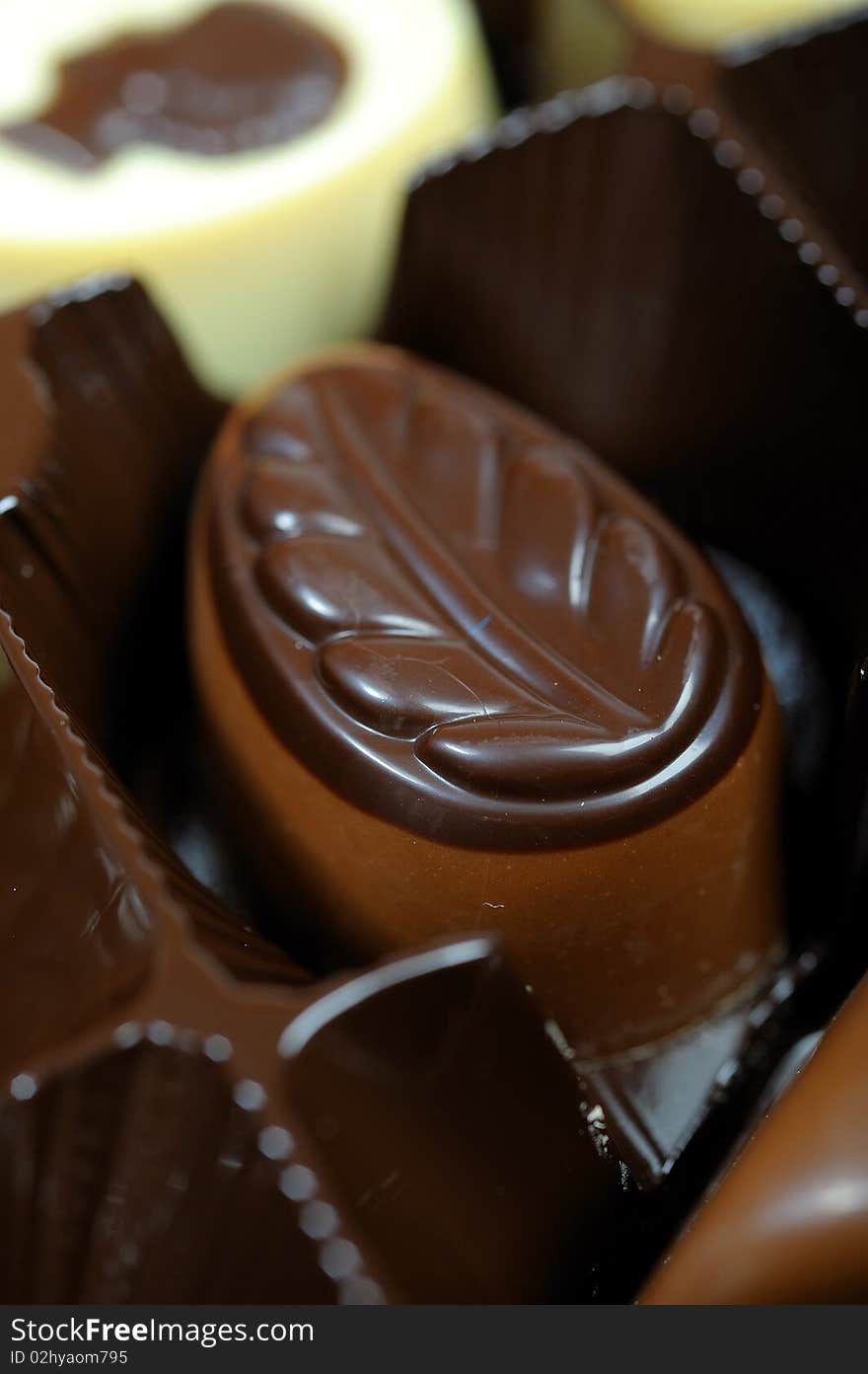 Delicious background of swiss dark chocolates, milk chocolates, pralines and truffles