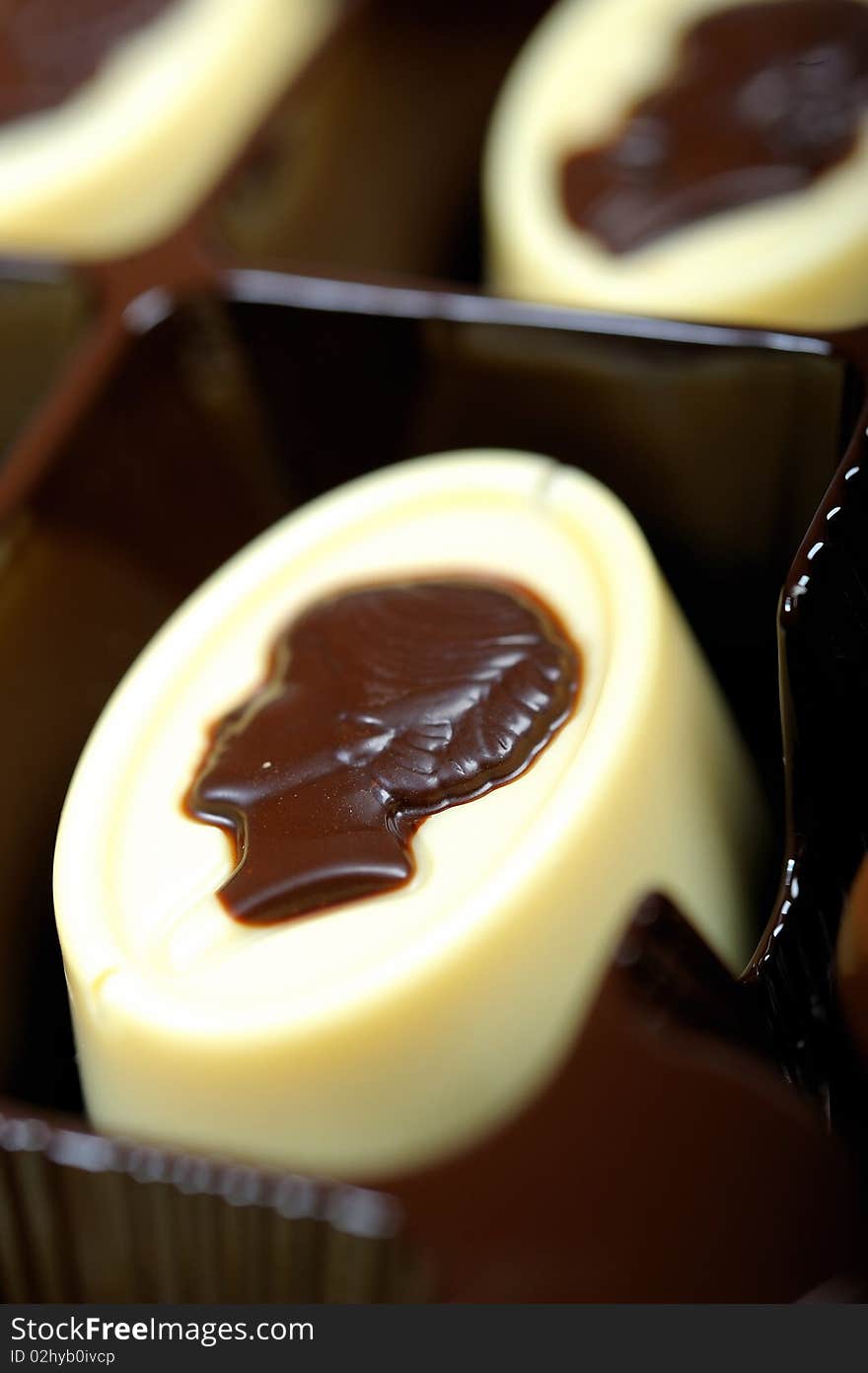 Delicious background of swiss dark chocolates, milk chocolates, pralines and truffles