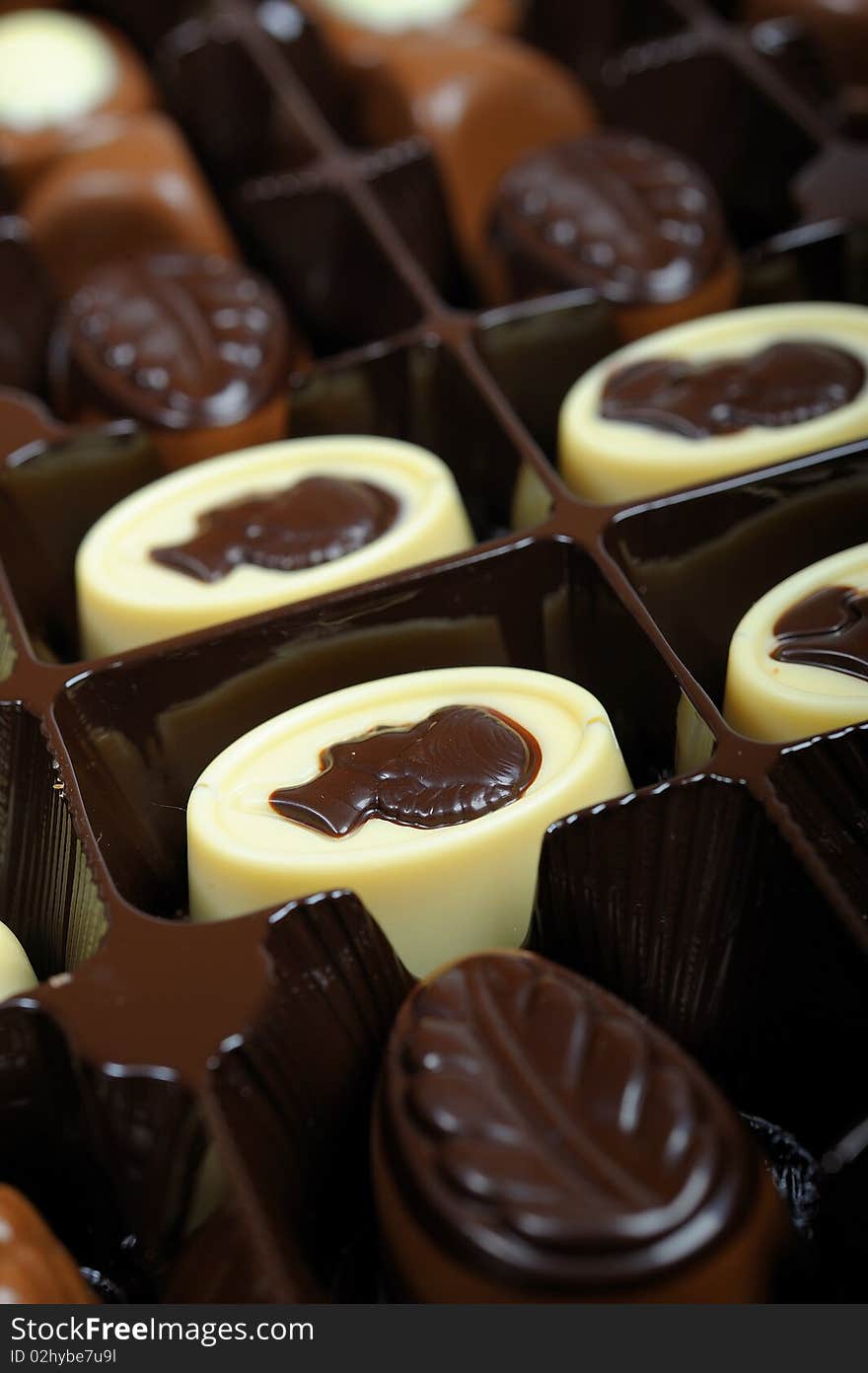 Delicious background of swiss dark chocolates, milk chocolates, pralines and truffles