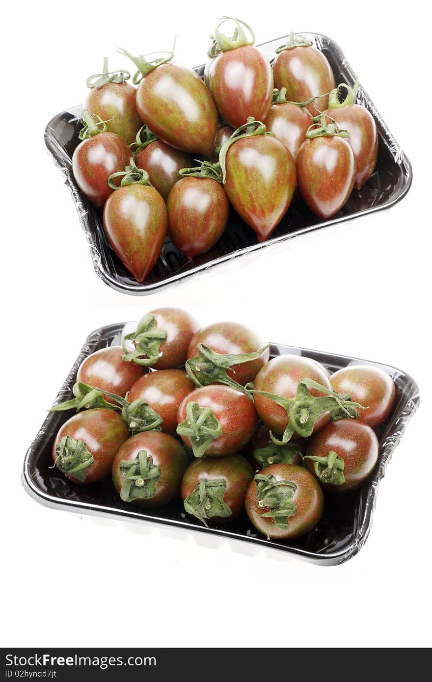 Two box of brown cherry tomatoes on white.