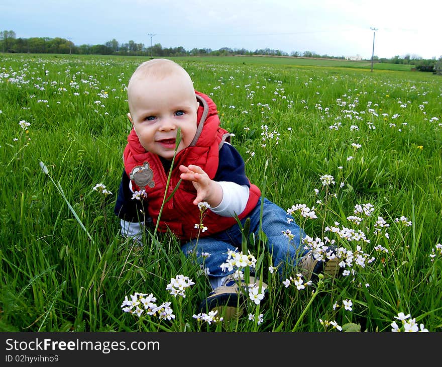 7 months baby boy siting at spring meadow. 7 months baby boy siting at spring meadow